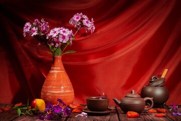Still life of flowers - summer blooming stems of plants. Draped background - theatrical stage...