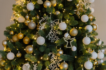 Christmas background from a Christmas tree decorated with golden toys, close-up