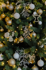 Christmas background from a Christmas tree decorated with golden toys, close-up