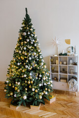 White Christmas interior with a beautiful Christmas tree decorated with toys