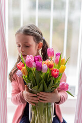 Portrait of smiling girl with tulips.