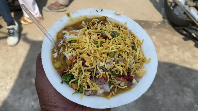 Close up shot of Aloo Tikki Chaat is a mouth watering Indian snack , Served with chana, Namkeen, Tomato Ketchup or Imli chutney.