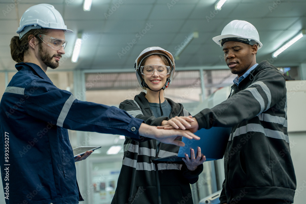 Aufkleber Engineering team are standing and join hands to celebrate the success of the work at robotic industry.