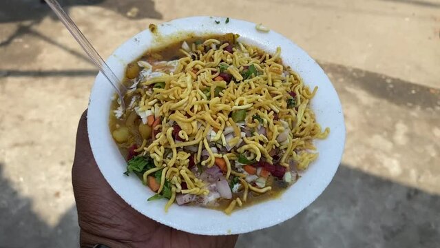Alu tiki chat with sev matar onion chilli and coriander leaves in road side shop in Dhobi, Gaya, Bihar.
