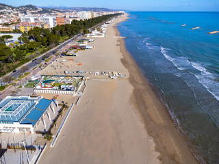 Aerial view landscape Italy Pescara. Long empty beach, sand, sea. Coast, promenade, buildings, estate.