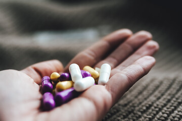 hands of a person with a lot of pills
