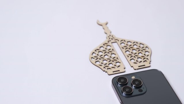 Smartphone with three lenses camera in islamic theme on white background. for ramadan kareem or eid mubarak events