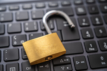 Open padlock, placed above a pc keyboard. Protection of personal and sensitive data, risk of...