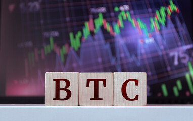 BTC - acronym from wooden cubes with letters, Bitcoin Cryptocurrency. Financial market concept