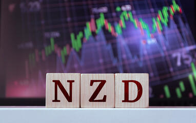NZD - acronym from wooden cubes with letters, New Zealand Dollars. Financial market concept
