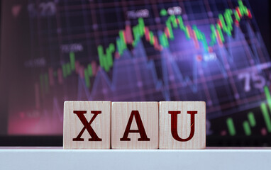 XAU - acronym from wooden cubes with letters, Gold. Financial market concept