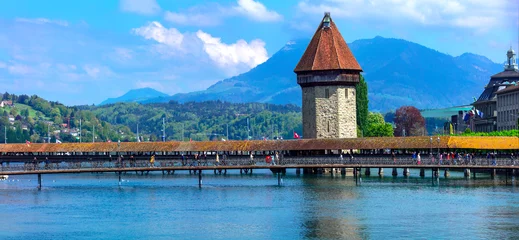 Fotobehang Panoramic view of Lucerne (Luzern) with famous Chapel  bridge  and Pilatus mountain on background. Switzerland travel and landmarks. © Freesurf