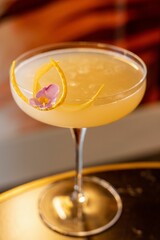 Closeup shot of a single yellow coctail in the glass.