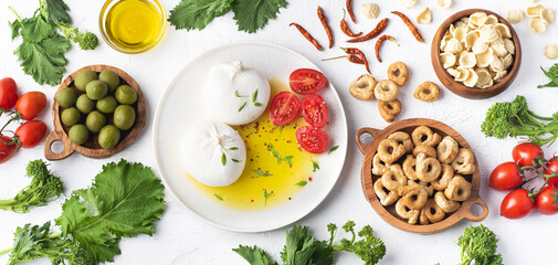 Pulian cuisine, the most famous ingredients of the south Italy: Burrata cheese, olive oil, homemade...