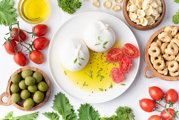 Pulian cuisine, the most famous ingredients of the south Italy: Burrata cheese, olive oil, homemade...