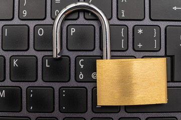 Open padlock, placed above a pc keyboard. Protection of personal and sensitive data, risk of...