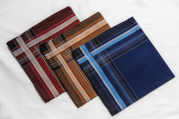 Set of vintage men's striped handkerchiefs on white fabric.