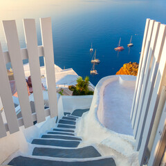 Gate to heaven. Santorini, Greece. White architecture, open doors and steps to the blue sea of Santorini.