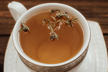 Herbal green tea in a white cup on the table.