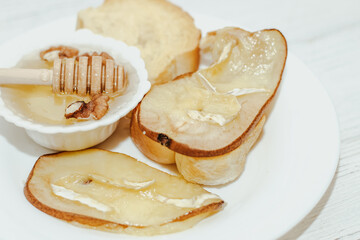 Camembert cheese with olive oil, rosemary, honey and baked pear.