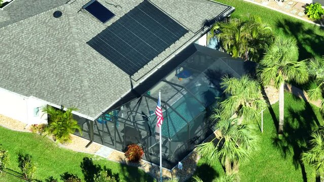 Thermal solar sanels installed on rooftop of a private house for swimming pool heating. Sun energy used to heat pool water in cold season