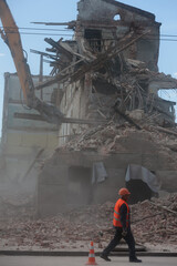Demolition of building. Excavator breaks old house. Freeing up space for construction of new building