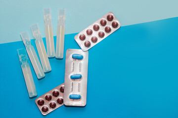 Probiotics medicine in vial on blue background.