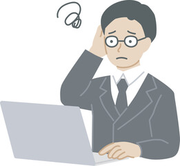 パソコンを操作しながら悩むスーツを着た男性