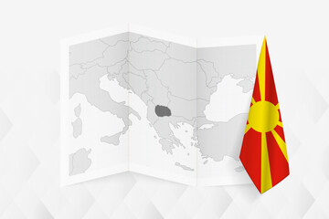 A grayscale map of North Macedonia with a hanging Macedonian flag on one side. Vector map for many types of news. - obrazy, fototapety, plakaty