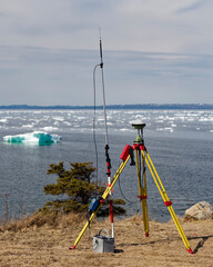 Modern surveying using gps technology near the coastline. Battery power is used for data...