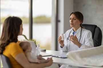Mother with little baby visiting pediatrician in clinic