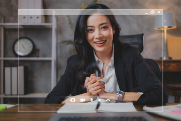 A business woman is using Video call on laptop to make an online conference. A beautiful confidence...
