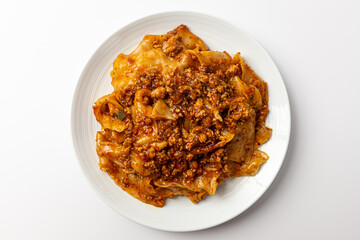 Fried noodles with mala sauce on white background