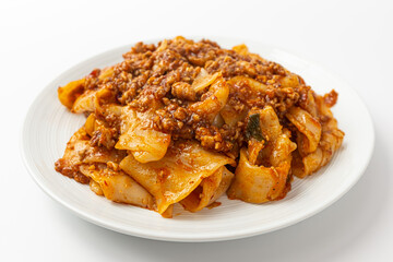 Fried noodles with mala sauce on white background