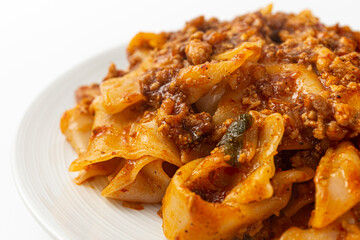 Fried noodles with mala sauce on white background