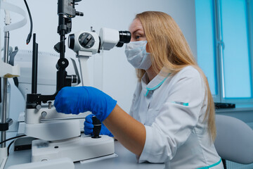 Portrait of a successful optometrist at work. Health care. Using professional equipment.