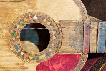 Sucre, Bolivia : Old Bolivian guitar. The instrument is decorated with colorful drawings and wooden marquetery. University Museum Colonial and Anthropological.