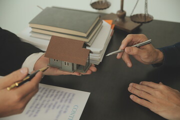 Justice and Law concept. Legal counsel presents to the client a signed contract with gavel and...