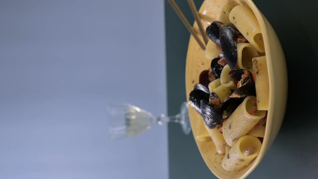 Italian pasta paccheri allo scoglio with mussels. Large Italian pasta with mussels and shrimps in sauce. From the South of Italy, typical Neapolitan pasta with seafood. High quality 4k footage