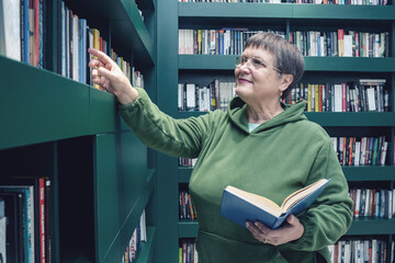 Grandmother with glasses in the city library.