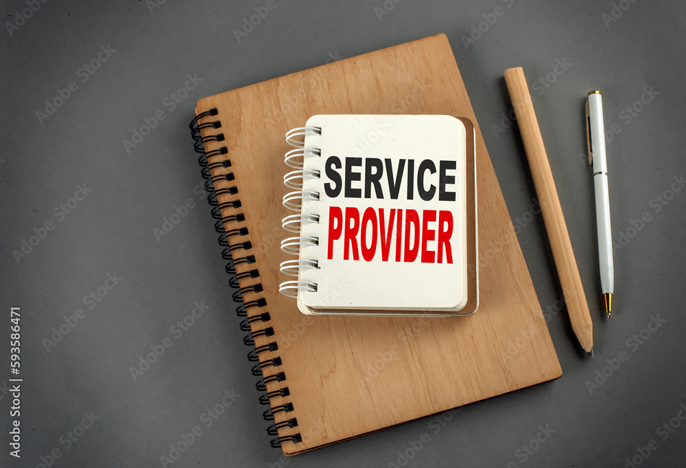 Poster service provider text on notebook with pen and pencil on grey background