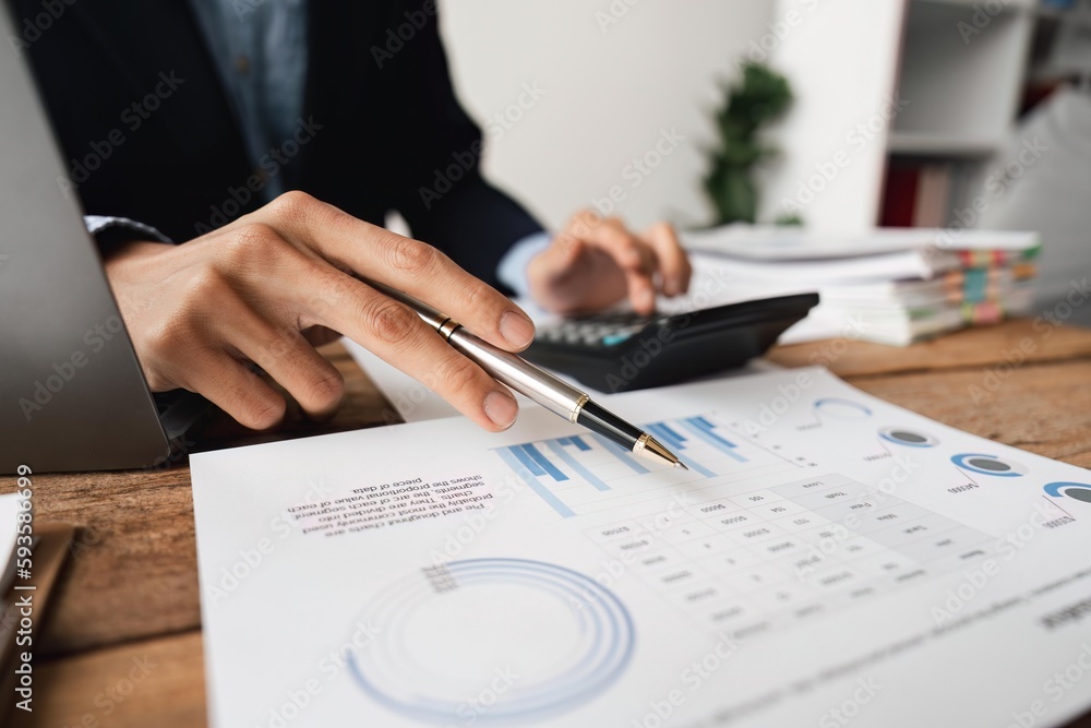 Poster businessman working on desk office with using a calculator to calculate the numbers, finance account
