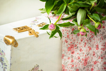 tender photo in vintage Provence style. Dress in flowers, an old suitcase and peonies flowers. Vintage