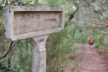 Signpost on the hiking trail or path showing the direction and distance in Madeira Island, Portugal, Europe