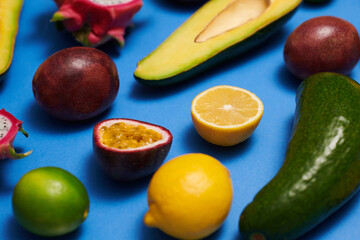 Fresh fruits and vegetables on blue surface