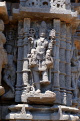 Fototapeta na wymiar 2 April 2023, Sculptures carved on the outer wall of the Laxminarayana temple one of the five rock temples inside Dharmaveergad / Bahadurgad, Pedgaon, Taluka Shrigonda, Maharashtra, India