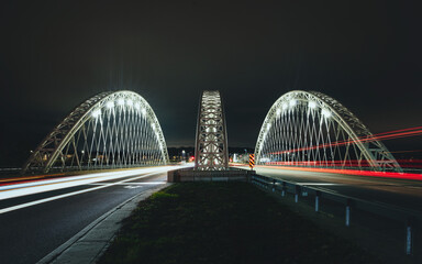 Strandherd-Armstrong Bridge, Now Called Vimy Memorial Bridge in Ottawa, Ontario, Canada, constructed 2014. Night  photo with traffic light trails from long exposure. Modern trestle suspension design.