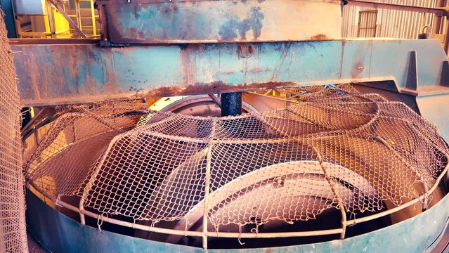 Static shot of industrial pressure rollers in action. Clay stones being mashed in slow motion 25perc. 4k.