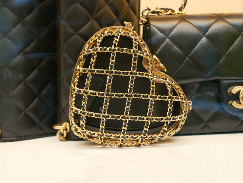 Chanel haute couture accessories : bag. Heart-shaped minaudière adorned with a golden chain