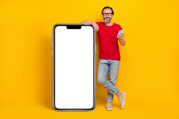 Photo of charming pretty guy pensioner dressed red t-shirt glasses typing gadget empty space...